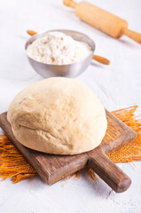 Photo of yeast puff pastry. Photo from above on the background of a wooden board.