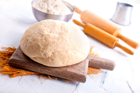 Photo of yeast puff pastry. Photo from above on the background of a wooden board.