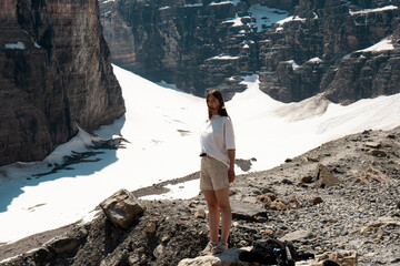 Young woman standing on rocky slope