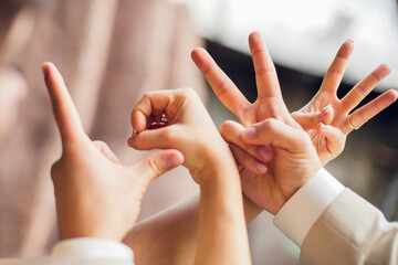 The word "Love" is formed using fingers. Sign language and symbols  © Olga