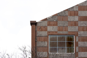 Contemporary facade with checkered pattern and industrial window. Architectural design with minimal...
