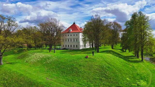 Drone shot pulling away, viewing the castle in the city of Birzai in Lithuania