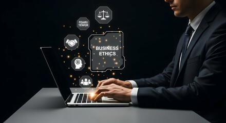 Businessperson working on a laptop with holographic icons related to business ethics displayed