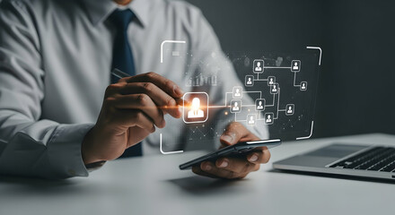 Businessman interacting with a holographic network of people on a smartphone, laptop in the background