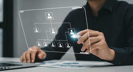 Person interacting with a digital organizational chart on a transparent screen