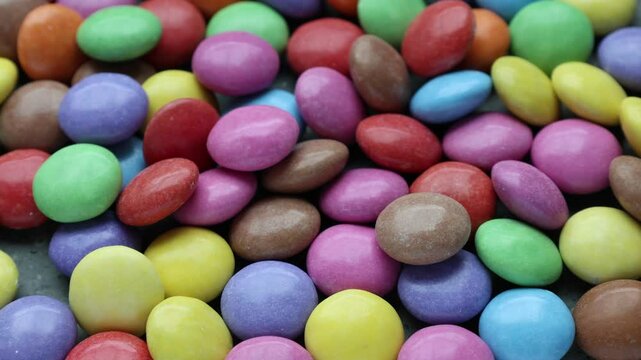 Plenty of colorful candies filled with chocolate. Close up video.