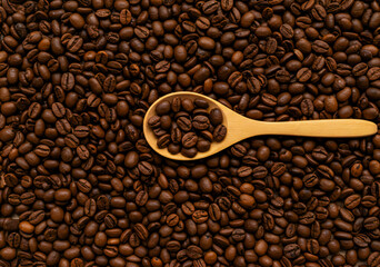 Obraz premium Coffee Beans Texture with Wooden Spoon