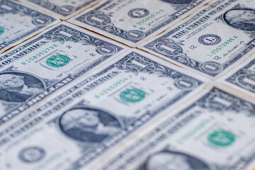 Rows of one-dollar bills arranged in a pattern. 