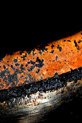 Close up of heavy black rust on a brass base of a kitchen sauce pan abstract background
