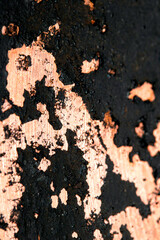Close up of heavy black rust on a brass base of a kitchen sauce pan abstract background