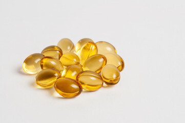 A collection of golden health supplements sits against a clean white background.