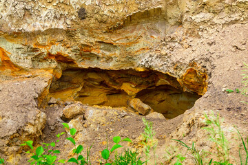 Hole in the ground with white and yellow clay and sand. Sedimentary rock mining in Ukraine, Kharkiv region