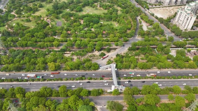 Top-down aerial shot of vehicles moving along a busy multilane highway.