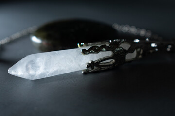 A powerful clear crystal quartz pendulum and a mesmerizing labradorite stone, embodying spiritual...