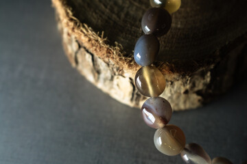 An earthy agate bead bracelet showcasing natural tones and patterns, elegantly displayed on a...