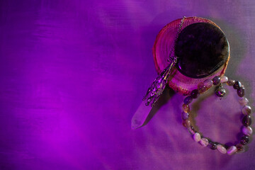A powerful arrangement of a labradorite stone, crystal quartz pendulum, and agate bracelet,...