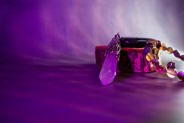 A powerful arrangement of a labradorite stone, crystal quartz pendulum, and agate bracelet,...