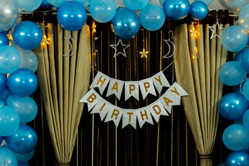 Elegant Blue and Silver Birthday Party Decorations: Balloons, Banner, and Fairy Lights.