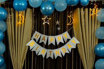 Elegant Birthday Party Decorations: Blue Balloons, Gold Stars, and Happy Birthday" Banner."