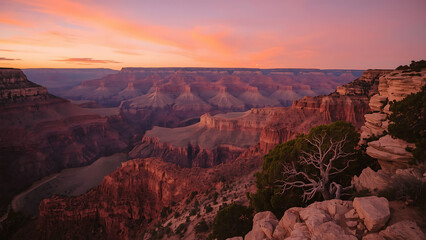 Grand Canyon National Park offers breathtaking Arizona desert landscapes, showcasing a majestic panorama of red rocks and mountains during sunrise and sunset over the Colorado River