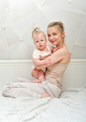Mother and baby playing and smiling. Happy family.Home interior.