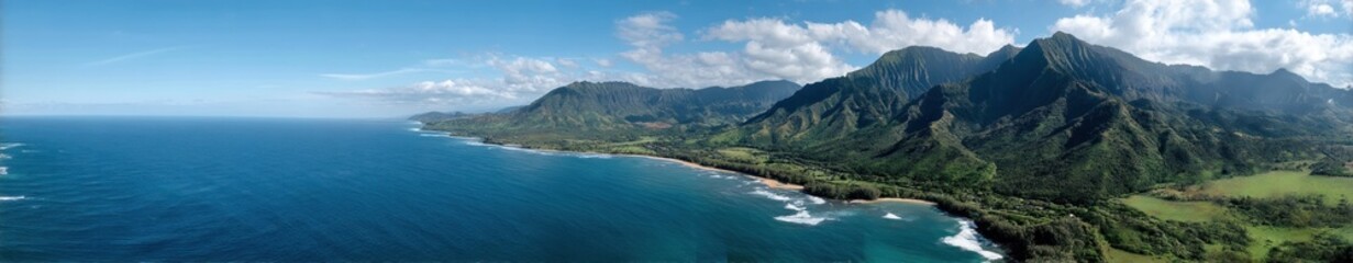 Panoramic view of lush green mountains and crystal blue ocean in hawaii.