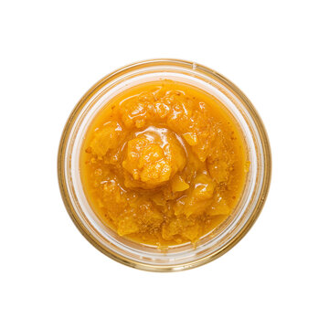 Close up shows vibrant cannabis concentrate in a jar, highlighting its amber color, and crystalline texture, perfect for illustrating extraction processes, transparent background