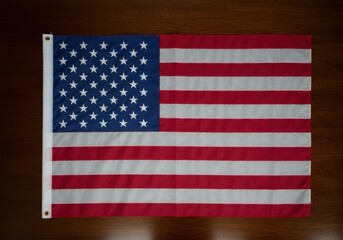 Fototapeta premium American flag on a dark wooden surface