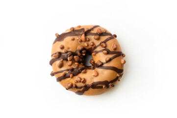 Delicious donut topped with chocolate drizzle and crunchy toppings served on a white background