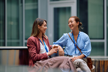 Happy female entrepreneurs talking during their coffee break at work.