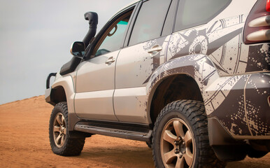 A powerful gray 4x4 SUV stands alone in the vast sandy terrain of the Namib Desert, ready for off-road travel, exploration, and endurance across one of Africa’s wildest landscapes. 