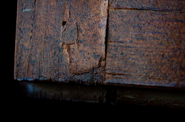 Close up of distressed aged wooden block showing rustic texture and weathering, ideal for vintage design elements or background textures.