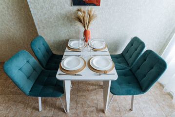 A warm dining room features a beautifully arranged table with an elegant centerpiece and four...