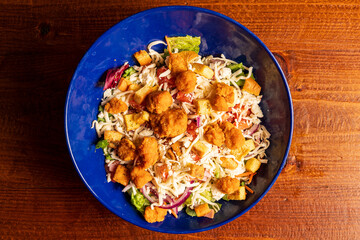 Salad with fried chicken nuggets