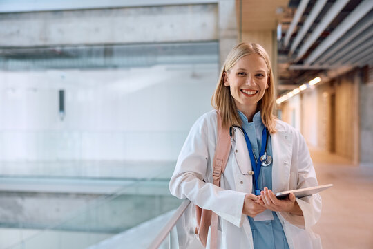 Happy female medical student at university looking at camera.