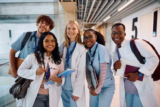 Multiracial group of happy medical students at university looking at camera.