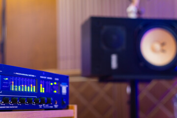 LED VU meter, audio meterbridge on loudspeaker monitor background in recording studio. music production, recording concept