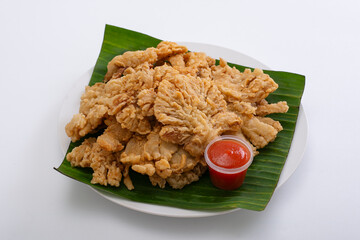 Indonesian street food crispy fried mushrooms with spicy tomato sauce on white background