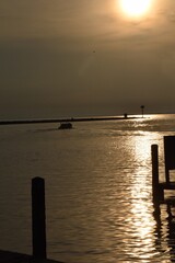 Obraz premium Angler fishing at sunrise in a boat