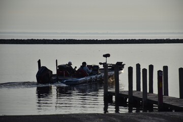 Angler fishing at sunrise in a boat