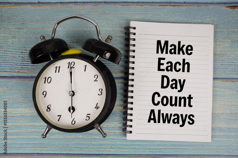 Poster make each day count always text written on notepad with alarm clock on wooden background