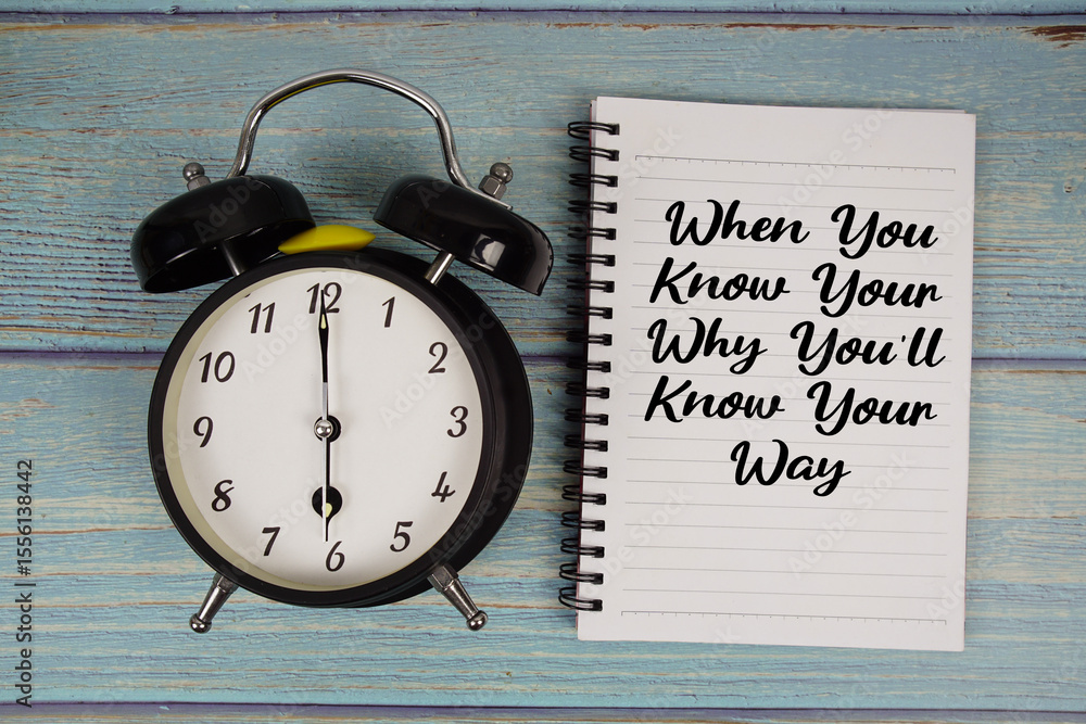 Poster when you know your why you'll know your way text written on notepad with alarm clock on wooden backg