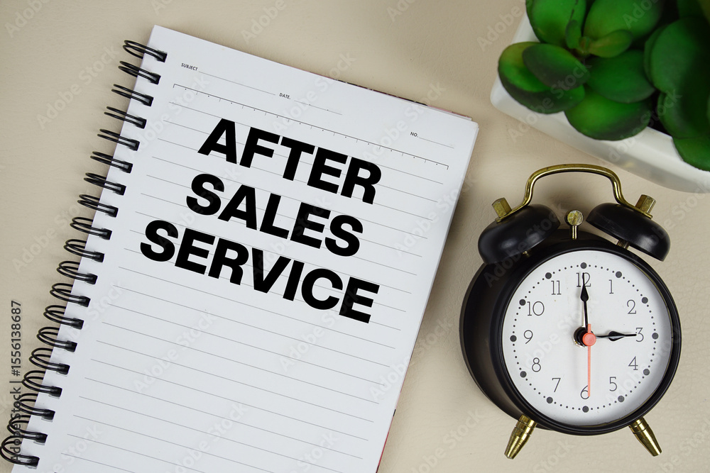 Poster after sales service text written on notepad with alarm clock