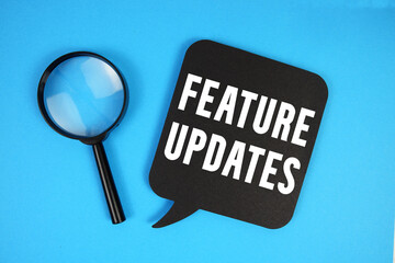 Feature Updates text with magnifying glass on blue background