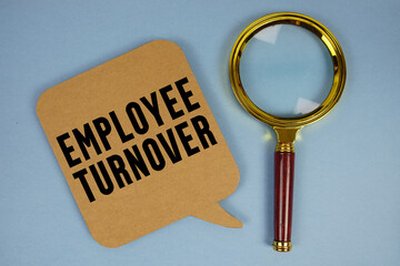 Employee Turnover text with magnifying glass on blue background