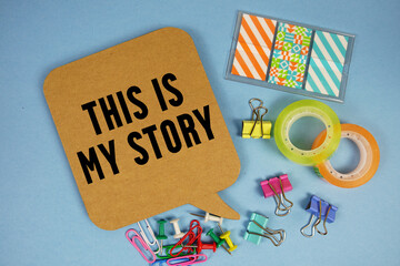 This Is My Story text with stationery on blue background