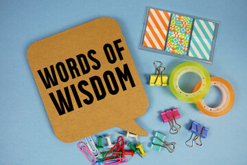 Words of Wisdom text with stationery on blue background