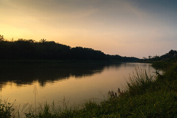 Peaceful River at Sunset with Reflections and Scenic Nature Surroundings