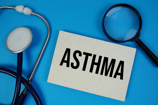 Asthma text with Stethoscope and magnifying glass on blue background