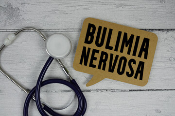Bulimia Nervosa text with Stethoscope on wooden background